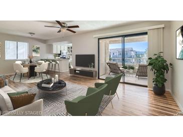 Open-concept living room boasts a modern design, sleek furniture, and sliding doors to a private balcony at 1963 Scimitar Dr # 0, Henderson, NV 89014