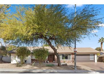 Single story home with mature landscaping and updated facade at 2192 Geronimo Way, Las Vegas, NV 89169