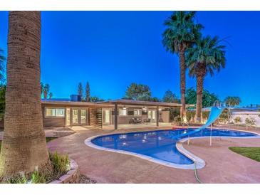 Inviting backyard with a refreshing pool, covered patio, and lush landscaping at 2505 Laurie Dr, Las Vegas, NV 89102