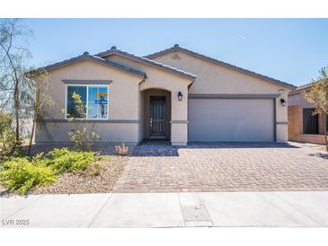 Single-story home with a two-car garage and attractive landscaping at 2905 Carothers Ct, North Las Vegas, NV 89032