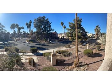 Exterior view of a well-maintained community with palm trees and desert landscaping at 2962 Juniper Hills Blvd # 203, Las Vegas, NV 89142