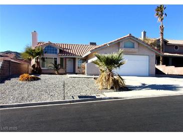 Single-story home with a two-car garage and desert landscaping at 3139 Ocotillo Dr, Laughlin, NV 89029