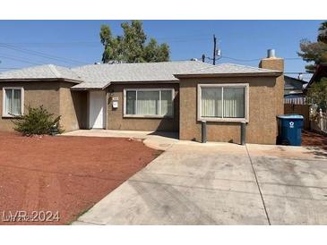 Ranch style home with a red rock front yard and driveway at 431 Bedford Rd, Las Vegas, NV 89107