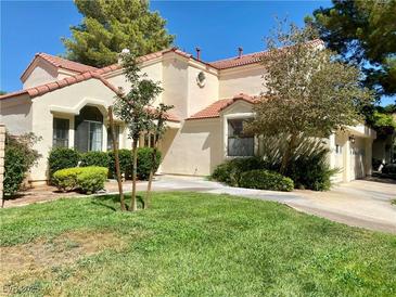 Two-story house with tile roof, landscaping, and a two-car garage at 5381 Waving Sage Dr, Las Vegas, NV 89149