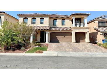 Two-story house with a brick driveway and landscaped front yard at 6454 Mount Palomar Ave, Las Vegas, NV 89139