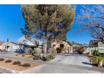 Charming single story home with a tree-lined front yard and large driveway at 659 I, Boulder City, NV 89005