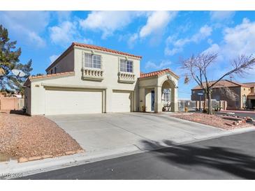 Two-story house with a two-car garage and landscaped front yard at 718 Glenwood Springs Ave, North Las Vegas, NV 89032