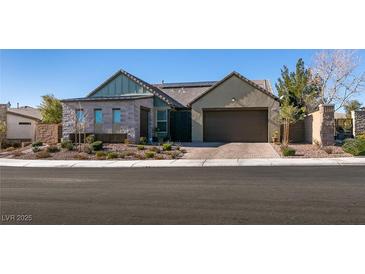 Single-story home with a modern design, two-car garage, and landscaped front yard at 8435 Great Outdoors St, Las Vegas, NV 89166