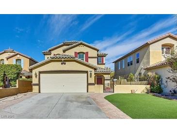 Two-story house with attached garage and landscaped lawn at 9516 Walking Spirit Ct, Las Vegas, NV 89129