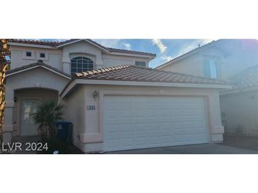 Two-story house with attached garage and landscaping at , Las Vegas, NV 89183