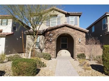 Two-story house with stone accents and a welcoming front porch at 1023 Desert Dome Ave, North Las Vegas, NV 89086