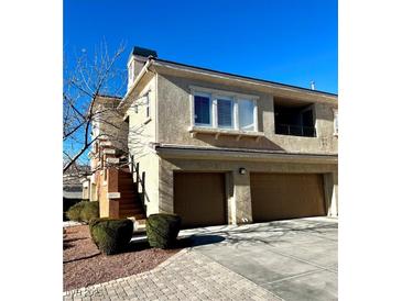 Well-maintained 2-story townhome with attached 2-car garage and landscaped grounds at 10809 Garden Mist Dr Dr # 2041, Las Vegas, NV 89135