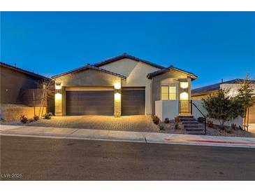 Stunning curb appeal with a two-car garage and well-manicured landscaping at 11870 Star Grass Ave, Las Vegas, NV 89138