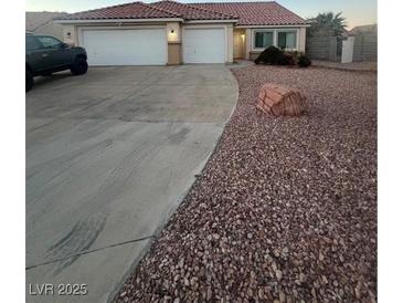 One-story house with three-car garage and desert landscaping at 1420 Ellen Tracy Way, Henderson, NV 89014