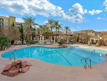 Resort-style pool with palm trees and a fire pit at 30 Strada Di Villaggio # 339, Henderson, NV 89011