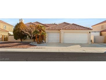 Single-story house with a two-car garage and landscaped front yard at 4120 Scotmist Ct, Las Vegas, NV 89129