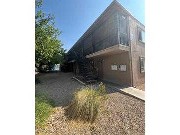 Two-story building with stairs and a small yard at 4186 Silver Dollar Ave # 8, Las Vegas, NV 89102