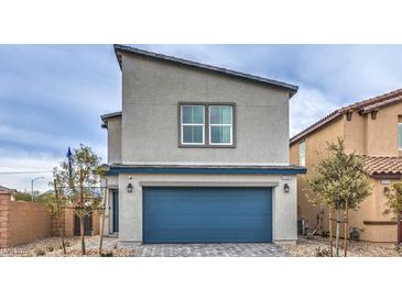 Modern two-story home with blue garage door and landscaped front yard at 5709 Scarlet Rock St, North Las Vegas, NV 89081