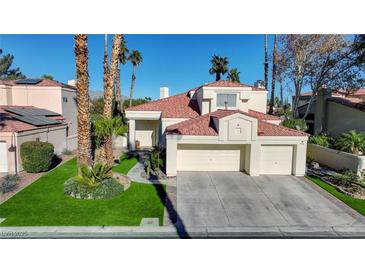 Beautiful two-story home with tile roof, two-car garage, and landscaped lawn at 7500 Orange Haze Way, Las Vegas, NV 89149