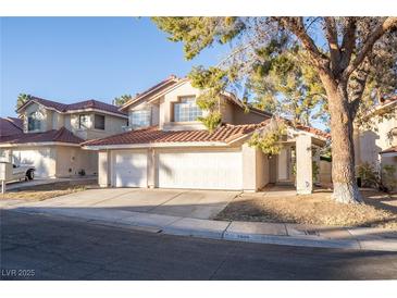 Two-story house with three-car garage and landscaped yard at 7608 Botany Bay Dr, Las Vegas, NV 89128