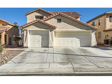 Two-story house with a three-car garage and landscaped front yard at 9154 Cazador St, Las Vegas, NV 89123