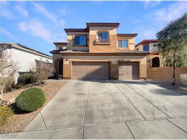 Two-story house with three-car garage and landscaped front yard at 170 Rolling Fields Ct, Henderson, NV 89012