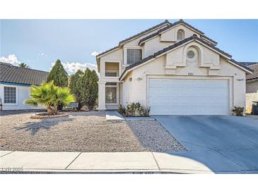 Charming two-story home with a well-manicured front yard and an attached two-car garage at 3425 Trilogy Dr, Las Vegas, NV 89108