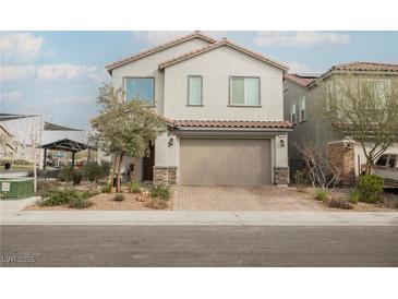 Charming two-story home featuring a well-manicured lawn and a two-car garage at 4372 Panoramic View Ave, North Las Vegas, NV 89084