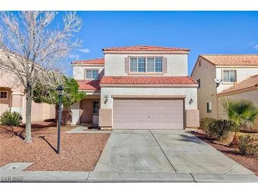 Two-story house with attached garage and landscaped front yard at 618 Lava Beds Way, North Las Vegas, NV 89084