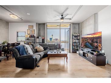 Spacious living room with city views, large TV, and comfortable seating at 353 E Bonneville Ave # 632, Las Vegas, NV 89101