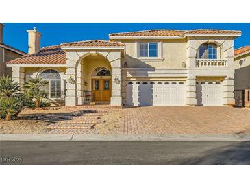 Two-story house with a brick driveway and a three-car garage at 6250 Pale Pavilion Ave, Las Vegas, NV 89139