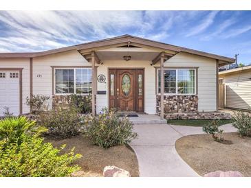 Inviting Ranch home features a charming front porch and well-manicured landscaping at 635 8Th St, Boulder City, NV 89005