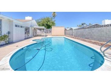Inviting kidney-shaped pool, perfect for relaxation at 7220 Stormson Dr, Las Vegas, NV 89145