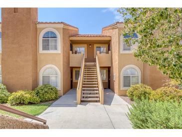 Charming condo building showcasing stucco facade, arched windows, and landscaped surroundings at 7950 W Flamingo Rd # 2056, Las Vegas, NV 89147