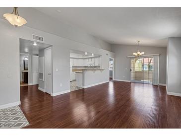 Bright living room with hardwood floors, fireplace, and high ceilings at 7950 W Flamingo Rd # 2056, Las Vegas, NV 89147