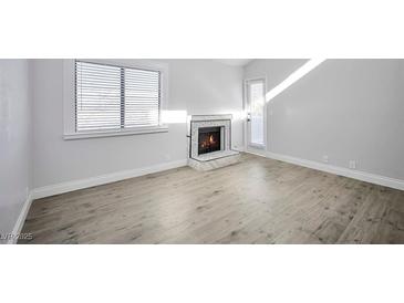 Bright living room with fireplace and wood-look floors at 1701 E Katie Ave # 10, Las Vegas, NV 89119
