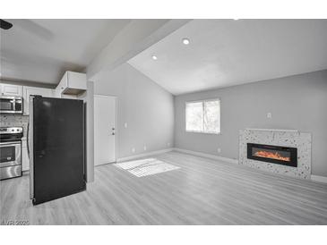 Bright living room with fireplace and laminate flooring at 1701 E Katie Ave # 32, Las Vegas, NV 89119