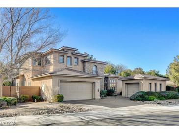 Two-story house with stone accents and a three-car garage at 29 Desert Highlands Dr, Henderson, NV 89052