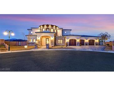 Stunning two-story home with a three-car garage and stone accents, beautifully lit at dusk at 5790 Aspen Falls Cir, Las Vegas, NV 89149