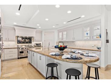 Gourmet kitchen with granite island, stainless steel appliances, and white cabinetry at 9101 Alta Dr # 505, Las Vegas, NV 89145