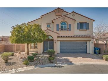 Two-story house with gray garage door and landscaping at 9893 Cove Haven Ct, Las Vegas, NV 89178