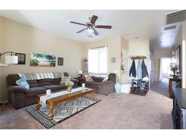 Cozy living room with a ceiling fan, neutral paint, and comfortable seating arrangement at 4625 Centisimo Dr # 202, North Las Vegas, NV 89084