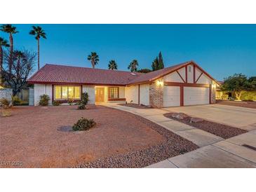 Brick house with a two-car garage and a landscaped front yard at 6466 Scotch Pine Cir, Las Vegas, NV 89146