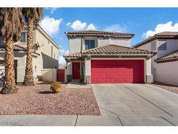 Two-story house with red garage door and desert landscaping at 3308 Salmon Creek Dr, Las Vegas, NV 89129