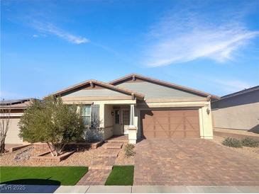 Single-story home with gray siding, brown garage door, and landscaped front yard at 480 Sterling Falls Ave, Henderson, NV 89011