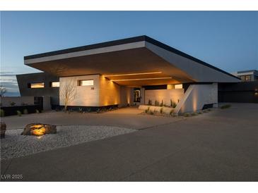 Modern home with sleek design, angular roofline, and landscaped entry at 705 Dragon Peak Dr, Henderson, NV 89012