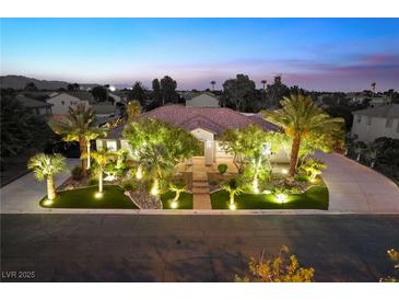 Beautiful single-story home with landscaped yard and night lighting at 7840 Thunder Echo St, Las Vegas, NV 89131