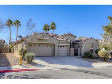 Two-story house with a three-car garage and desert landscaping at 869 Ashford Way, Henderson, NV 89015