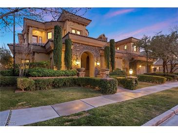 Elegant two-story home boasting a stone facade, manicured landscaping, and a welcoming entryway at 10923 Willow Heights Dr, Las Vegas, NV 89135