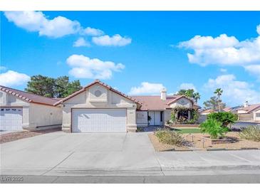 Charming single-story home with a well-manicured front yard and attached two-car garage at 2829 Forrest Duke Ct, Las Vegas, NV 89108